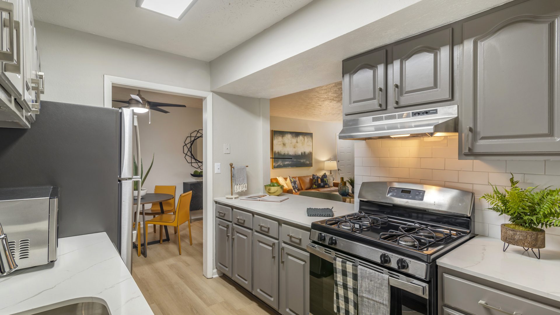 kitchen with stainless steel appliances and gray cabinets at The  Bowie